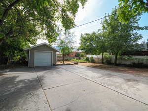Detached garage featuring concrete driveway