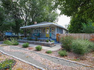 Bungalow-style house with covered porch and a chimney