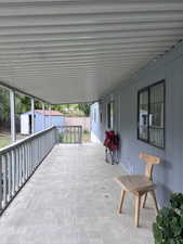 View of patio featuring a shed