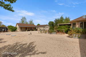 View of yard with a vegetable garden and a patio area