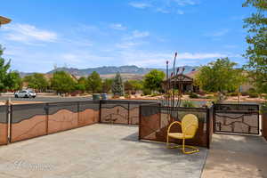 View of patio with a mountain view and a gate