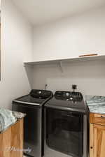 Laundry room featuring cabinet space and washing machine and dryer