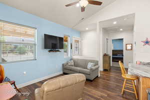 Living area with dark wood-style floors, lofted ceiling, a ceiling fan, and recessed lighting