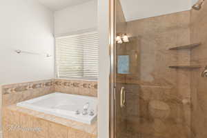 Full bathroom with a shower stall and a garden tub