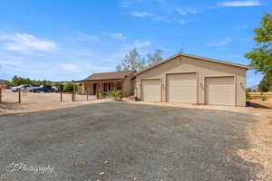 View of front of property with stucco siding, driveway, and a garage