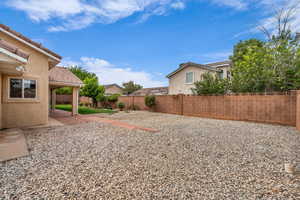 Fenced backyard with a patio