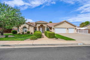 Mediterranean / spanish house with stucco siding, concrete driveway, a garage, and a tiled roof