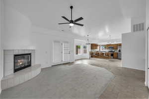 Living area with a fireplace and ceiling fan