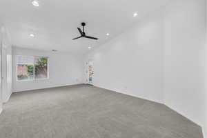 Spare room featuring light colored carpet, recessed lighting, and a ceiling fan