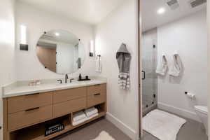 Full bathroom featuring vanity, light tile patterned flooring, and a stall shower