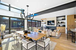 Dining space with a chandelier, light wood-type flooring, and recessed lighting