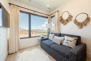 Sitting room with wood finished floors, a mountain view, and recessed lighting