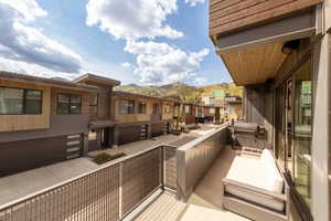Balcony featuring a residential view and a mountain view