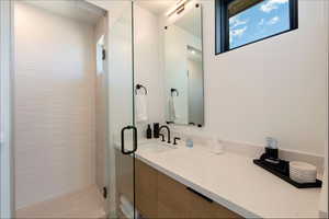 Full bath with vanity and a shower stall