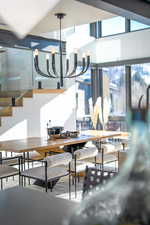 Dining area with a chandelier and stairs