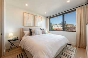 Bedroom with light wood-style floors and recessed lighting