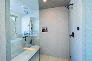 Full bathroom featuring a walk in shower, recessed lighting, and light tile patterned floors