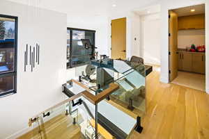 Home office with light wood-type flooring and recessed lighting