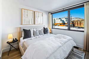 Bedroom featuring wood finished floors and baseboards