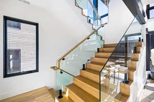 Stairway featuring wood finished floors and baseboards