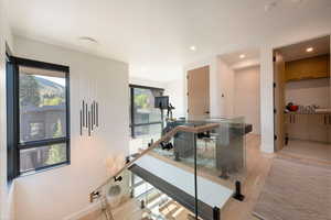 Workout area with light wood-style flooring and recessed lighting