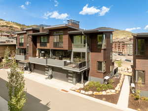 View of building exterior with concrete driveway and an attached garage