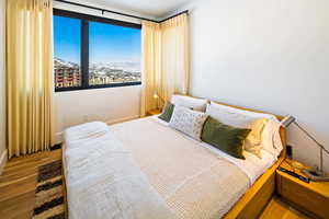 Bedroom featuring wood finished floors and a mountain view