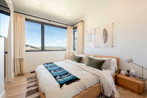 Bedroom featuring wood finished floors, a mountain view, and recessed lighting