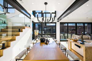 Dining space with stairway, recessed lighting, and a chandelier