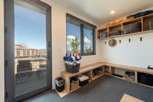 Mudroom featuring light carpet