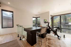 Office space with light wood-type flooring and recessed lighting