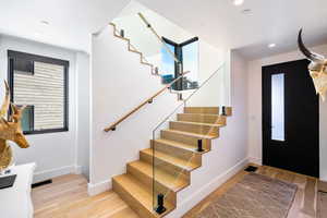 Entrance foyer with stairway, light wood-style flooring, and recessed lighting