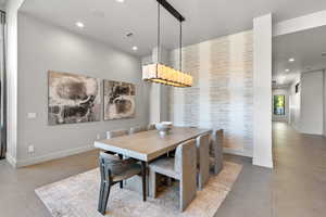 Dining space with recessed lighting and baseboards