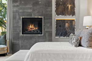 Bedroom with a tiled fireplace