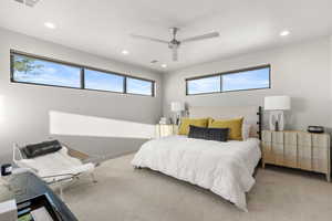 Carpeted bedroom with recessed lighting and a ceiling fan