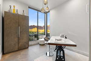 Dining room with expansive windows, a desk, and light tile patterned floors