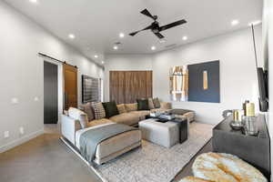 Tiled living area with a barn door, recessed lighting, and a ceiling fan