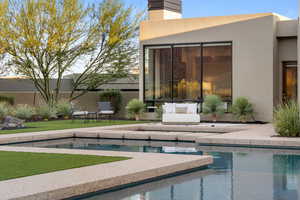 Outdoor pool featuring a patio and a yard