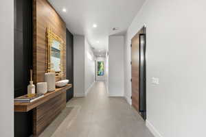 Corridor with recessed lighting and light tile patterned flooring
