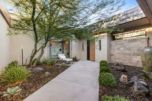 View of exterior entry with stucco siding and oil tank