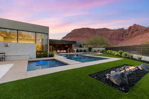 View of pool with a patio, a fenced backyard, a mountain view, and an outdoor living space with a fire pit