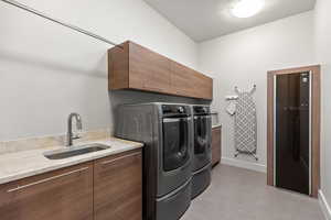 Washroom with washer and dryer and cabinet space