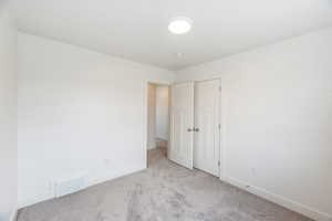 Unfurnished bedroom with carpet floors and a closet