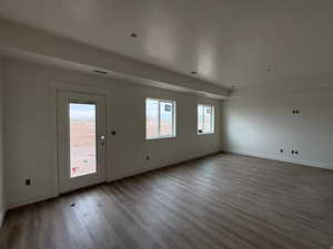Entrance foyer with baseboards and wood finished floors