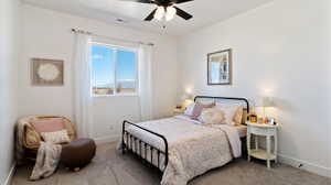 Bedroom with a ceiling fan and carpet floors