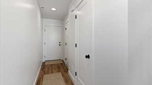 Hall featuring dark wood finished floors and recessed lighting