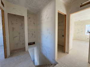 Hallway with a textured ceiling