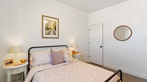 Bedroom featuring carpet floors and baseboards