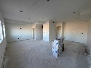 Unfurnished room with unfinished concrete floors