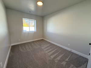 Spare room with carpet flooring and baseboards